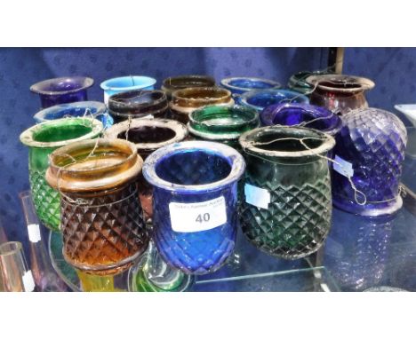 A COLLECTION OF VICTORIAN MOULDED GLASS TEA LIGHT HOLDERS including 'Brock's' examples