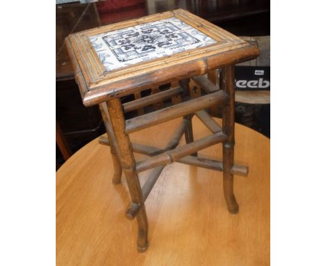 A VICTORIAN BAMBOO PLANT STAND with inset blue tile top, 12" wide