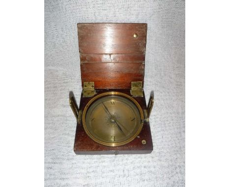 A BRASS COMPASS with folding sights, signed 'Troughton, Maker 136, Fleet Street, London', with decorative engraved centre and