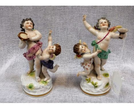 A PAIR OF CONTINENTAL CERAMIC MODELS of Cherubs Cavorting
