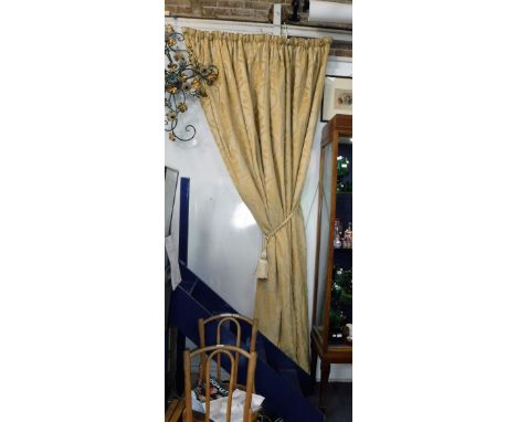 AN EXTENSIVE SUITE OF GOLD VELVET DAMASK CURTAINS, each lined and interlined, with tie backs, sections of pelmet and side dro