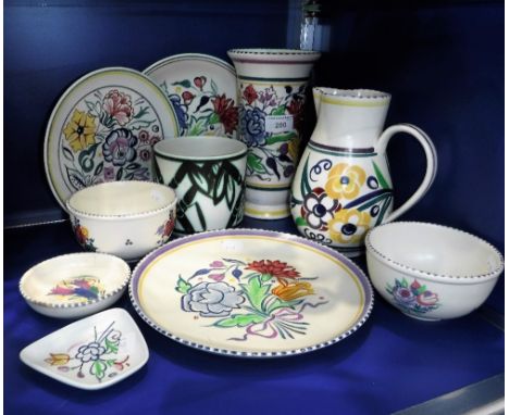 A COLLECTION OF POOLE POTTERY including traditionally decorated vases and plates 