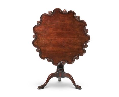 A GEORGE II MAHOGANY TRIPOD TABLE  CIRCA 1750 With a lobed and shell carved tilt top on a later birdcage and turned fluted pe