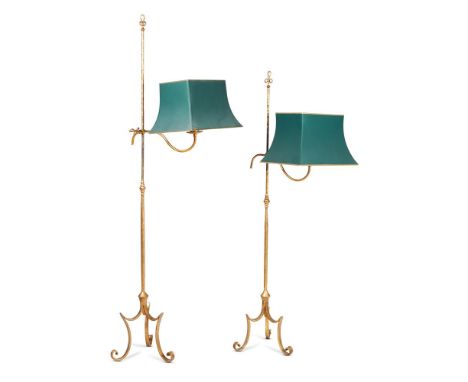 TWO GILT IRON READING LAMPS  20TH CENTURY  With loop twist tops above height adjustable light fitments, with green and gilt s