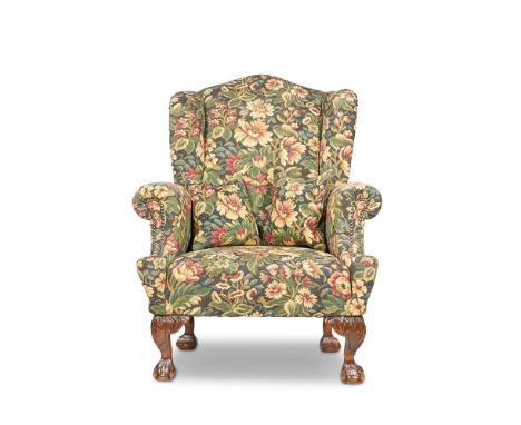 A BEECH AND FLORAL 'TAPESTRY' UPHOLSTERED WING ARMCHAIR 20TH CENTURY With webbed claw and pillow feet 115cm high, 87cm wide, 