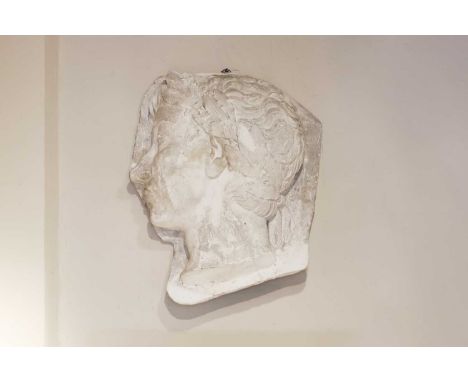 A Roman-style plaster portrait relief, 20th century, in the form of Augustus wearing a laurel wreath,52cm wide19cm deep62cm h