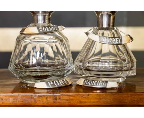 A set of four silver-mounted boar tusk decanter labels, early 20th century, Indian, comprising 'SHERRY', 'WHISKEY', 'PORT' an