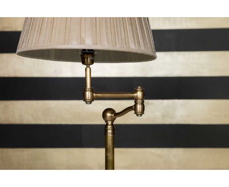 A brass standard lamp,  of recent manufacture, with a rotating arm over a plain shaft and circular base, shade not included, 