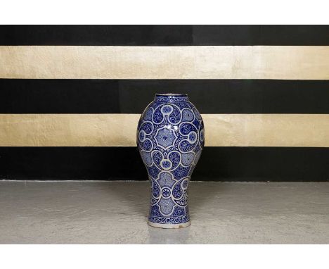A large blue and white ceramic vase, 19th century, Moroccan, with stylised decoration, 35cm diameter70cm high