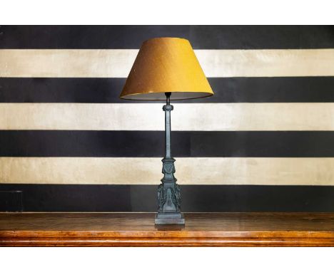 A Roman-style bronze table lamp, c.1800, Italian, the square column raised on a stepped base set with four griffins, shade no