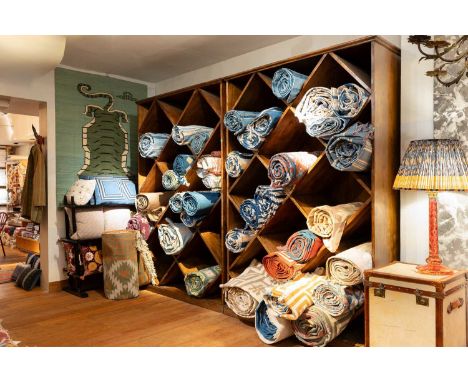 A pair of teak carpet shelves, late 20th century, Indian, each with eighteen, open, diamond-shaped shelves,155cm wide61cm dee