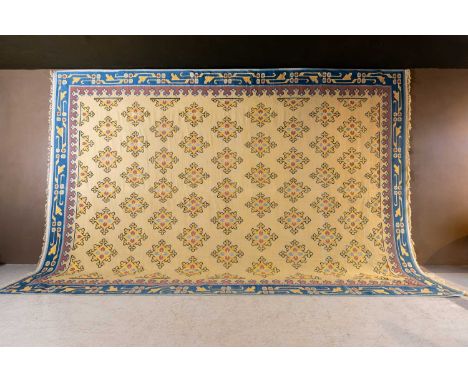 A large flat-weave dhurrie carpet, c.1900, Indian, with medallion motifs to an indigo and purple border, on a yellow-gold gro