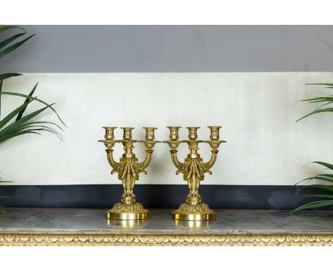 A pair of Louis XVI ormolu candelabra in the manner of Delafosse of Paris,  c.1770, each with three branches and central flam