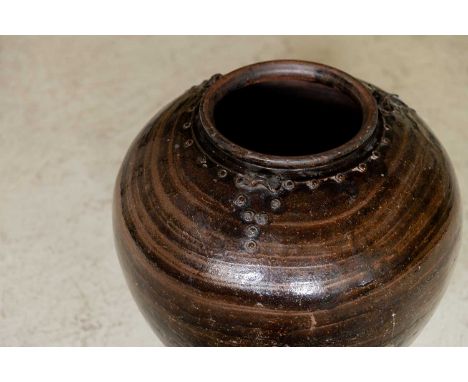 A black-glazed terracotta water jar, 19th century, Chinese,57cm wide63cm highCondition ReportSome light surface scratches to 