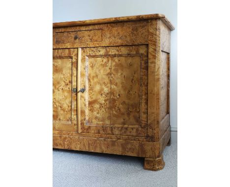 A Karelian birch commode,  c.1830, Continental, with a drawer and cupboards, on shaped bracket feet, 120cm wide 44cm deep 94c