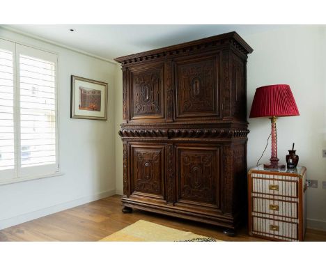 A Louis XIII walnut buffet à deux corps, 17th century, with carved panel doors and gadrooned detail, raised on bun feet,168cm