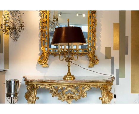 A polished brass bouillotte lamp, 19th century, French, with four branches and a toleware shade, 55cm diameter 91cm highCondi
