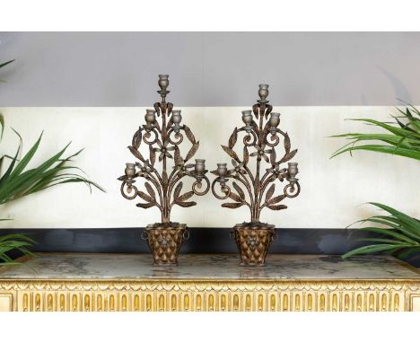 A pair of gilt-iron five-light candelabra, c.1930, Continental, each with stylised foliage and scrolls, 31cm wide14cm deep63c