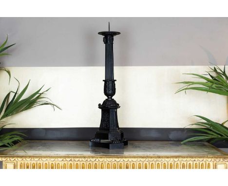 A large Empire-style pricket candlestick, 19th century, French, the iron reeded column on a triform base and lion paw feet,26