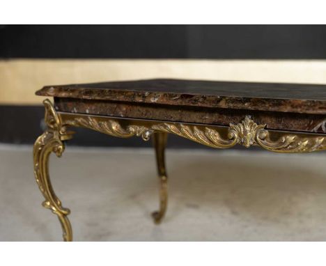 A fossilised ammonite marble and gilt-brass coffee table, c.1960, French, raised on scrolling foliate cabriole supports,102cm