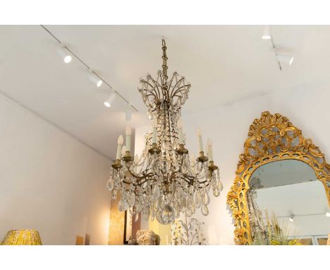A cut-glass chandelier, c.1900, French, in the Baccarat style, the bronze twelve-light frame with a central ball and pendant 