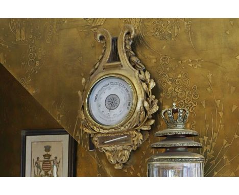 A Louis XVI-style giltwood aneroid barometer,  19th century, French, of lyre form with foliate decoration, 40cm wide 15cm dee