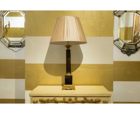 An Empire-style gilt and patinated bronze lamp, c.1890, French, with an acanthus capital above a fluted column, raised on a s