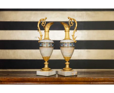 A pair of Louis Philippe onyx and ormolu-mounted champagne ewers, c.1850, French, each with champlevé enamel mounts, on a squ