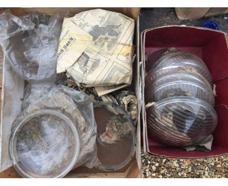 A box of original headlamp glasses. 