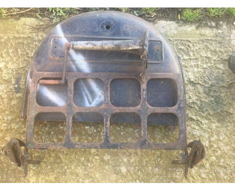 An Austin 7 ruby rear wheel cover, a luggage rack and a front nose cone with starting handle. 