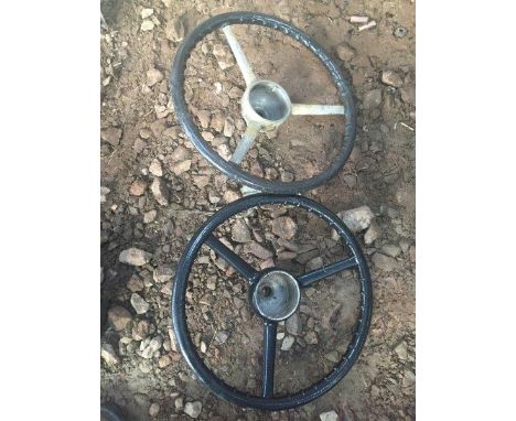 Two Austin 7 ruby steering wheels, one appears recovered. 