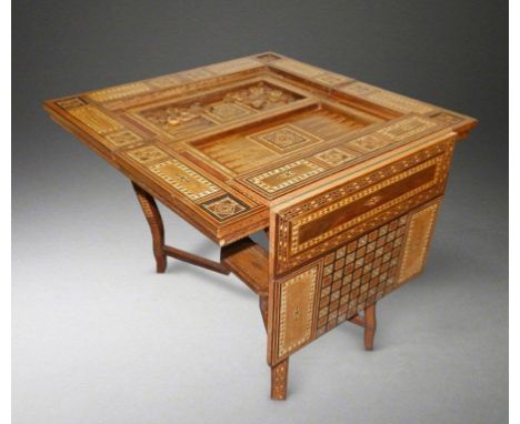 A 19thC Syrian parquetry & mother-of-pearl inlaid folding card table, decorated to all surfaces, having two small apron drawe