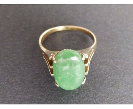 A jade set solitaire ring in '18k' yellow metal 