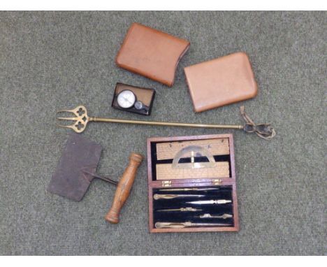 An unopened pack of De La Rue playing cards, a small sundial, a drawing set and other items