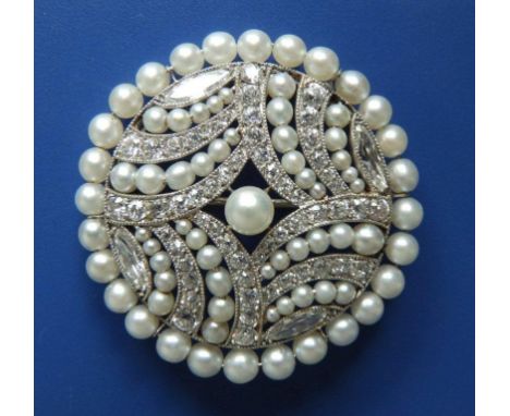 A diamond & natural pearl circular brooch, of openwork panel design, millegrain set in white metal with four marquise cut dia