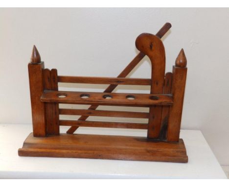 A wooden pipe stand in the form of a five-bar gate