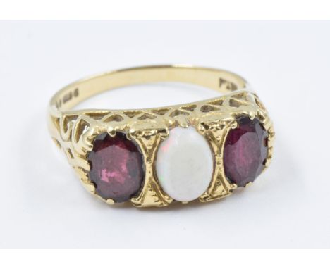 9ct Yellow gold dress ring set with an oval opal flanked by two garnets, size 'P', 3.5g