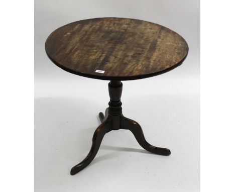 George III oak circular pedestal table, the tilt top above a baluster turned column support and tripod base, 73cm diameter