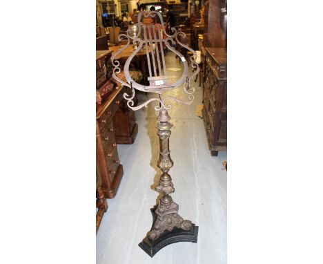 Reproduction patinated brass music stand, the lyre form top above a 17th Century style baluster column and tripod base, 136cm