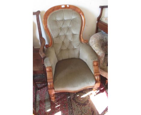 Victorian drawing room armchair with buttoned green upholstery on turned supports