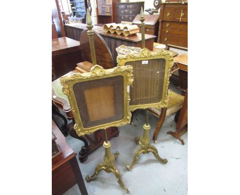 Pair of Victorian giltwood and ghesso firescreens on tripod bases, 138cm high