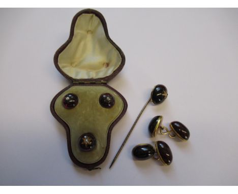 Cased set of three cabochon garnet and rose cut diamond dress studs, together with a similar stick pin and a pair of cabochon