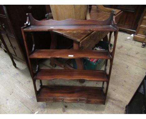 Reproduction mahogany four shelf wall bracket in Chippendale style, with pierced sides and three small drawers to the base, 9