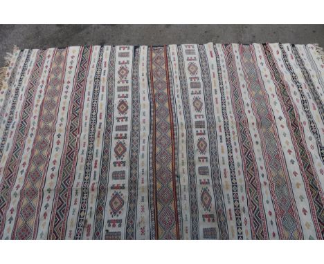 Soumak carpet with banded design on an ivory ground, 293 x 190cm