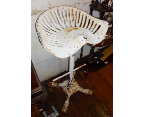 Cast-iron garden stool with tractor seat