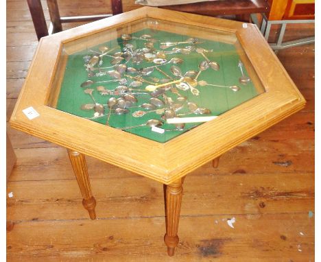 Light oak octagonal display table (vitrine) on turned legs, together with a collection of souvenir spoons