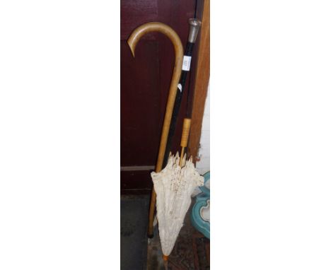 Silver-topped walking cane, a parasol and a walking stick