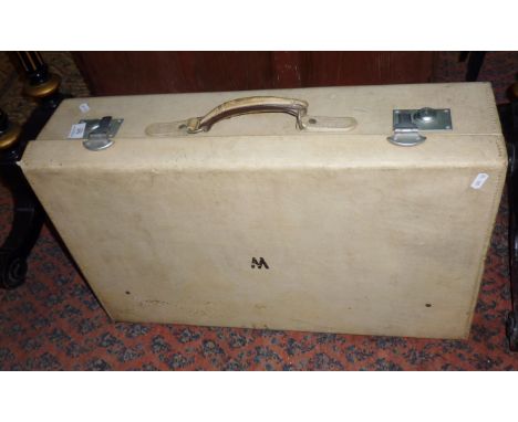 Vintage white leather suitcase with luggage label