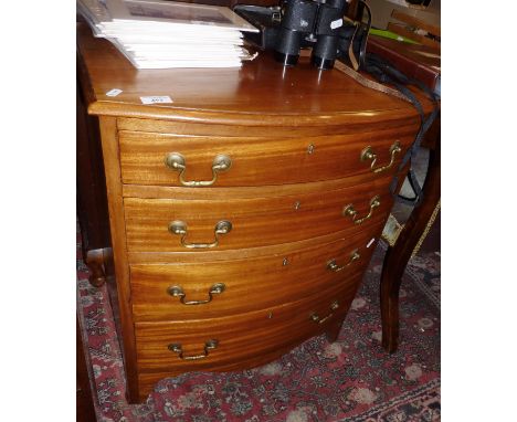 Mahogany bow fronted chest of four drawers with brass handles on four bracket feet