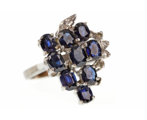 EIGHTEEN CARAT WHITE GOLD SAPPHIRE AND DIAMOND DRESS RING1960s, with oval sapphires each approximately 5mm long set a varying